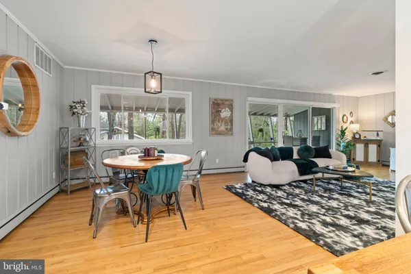 a living room with furniture windows and wooden floor