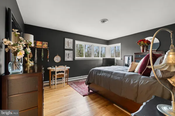 a living room with lots of furniture and clutter