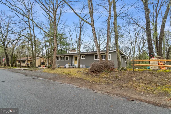 a large kitchen with stainless steel appliances lots of counter space wooden floor and window