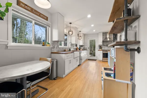a kitchen with a sink a stove and chairs