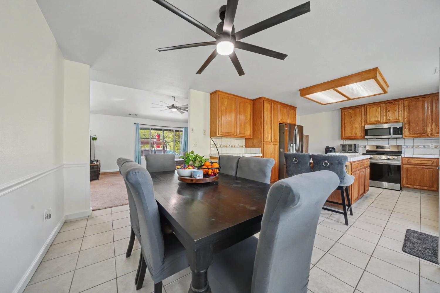 7761 Jenny Lind Road Valley Springs, CA 95252 - Photo 11 of 35 a view of kitchen with dining table and chairs