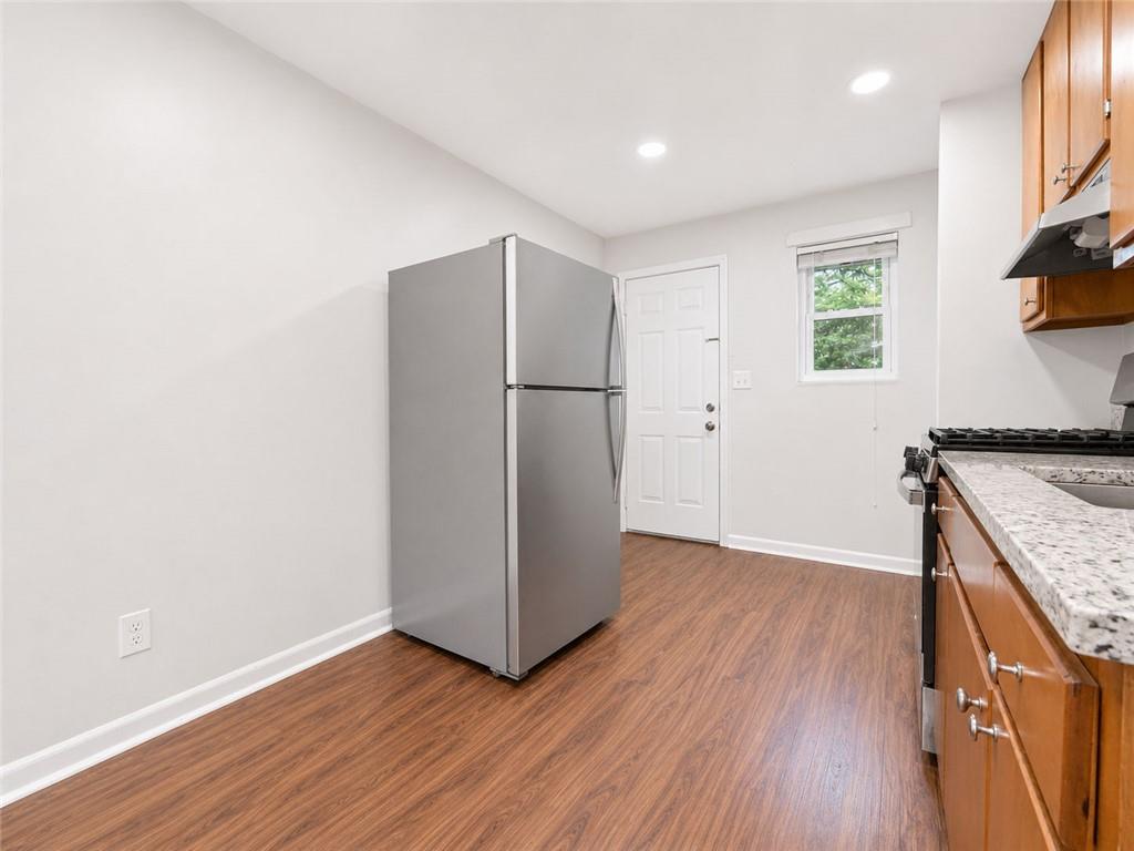 3203 East Point Street, Unit 4 Atlanta, GA 30344 - Photo 6 of 18 an empty room with wooden floor and a window