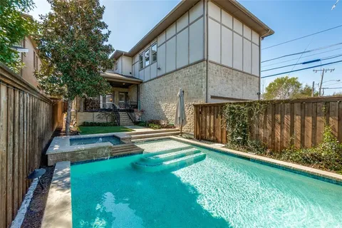a view of backyard with wooden fence and large trees