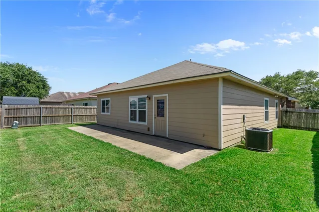 a backyard of a house with wooden fence