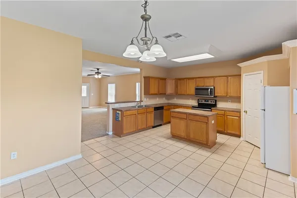 a kitchen with a refrigerator and microwave