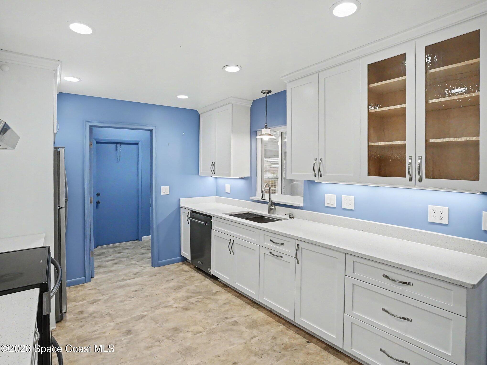 1870 Tallpalm Road Melbourne, FL 32935 - Photo 11 of 30 a spacious bathroom with a granite countertop sink a mirror and a