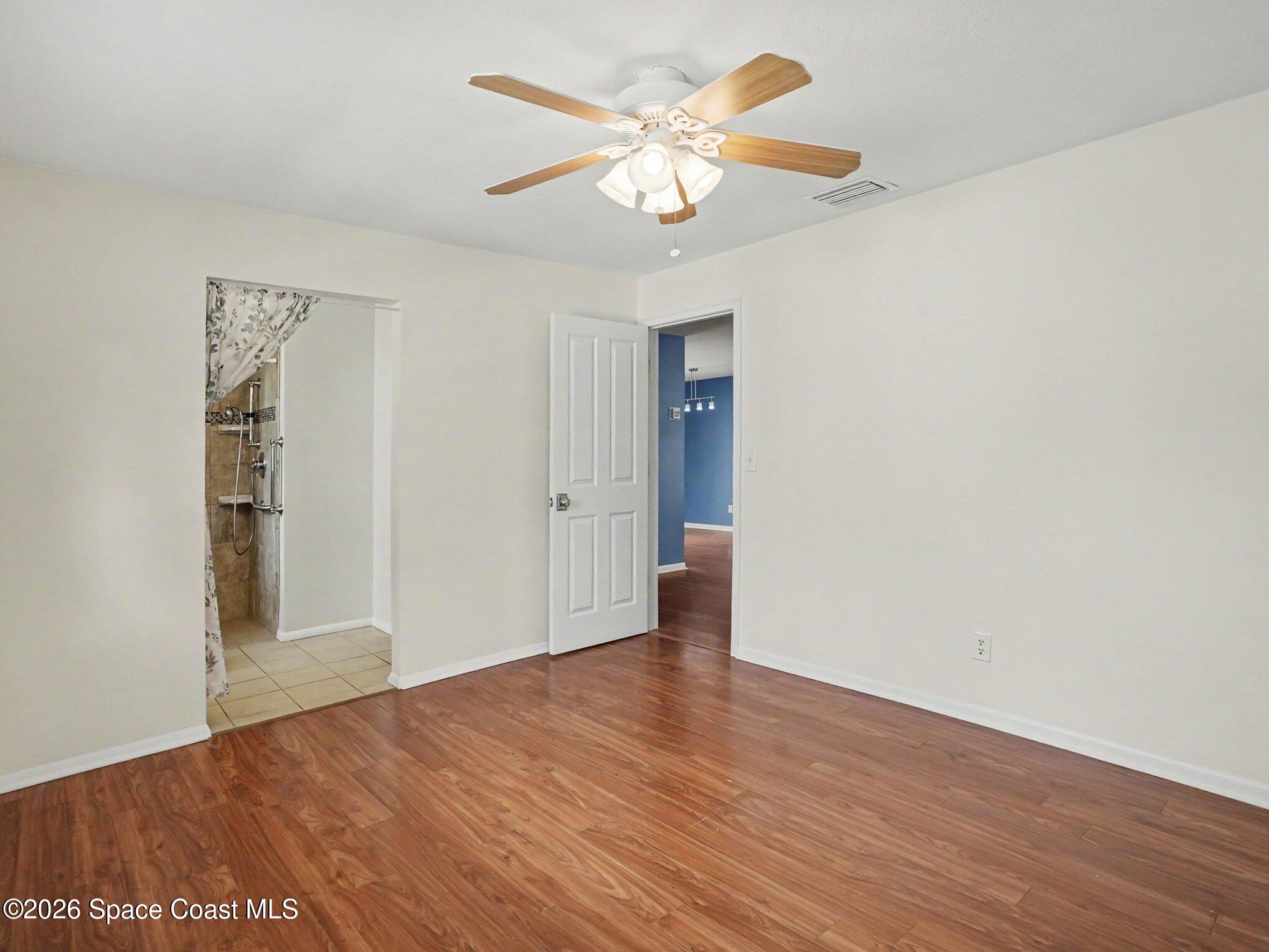 1870 Tallpalm Road Melbourne, FL 32935 - Photo 14 of 30 a view of an empty room with wooden floor