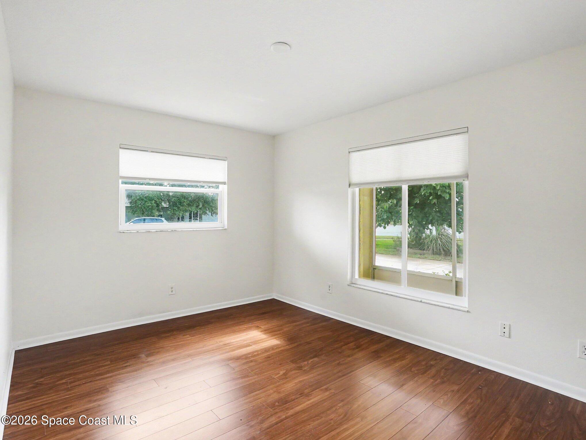 1870 Tallpalm Road Melbourne, FL 32935 - Photo 18 of 30 an empty room with wooden floor and windows