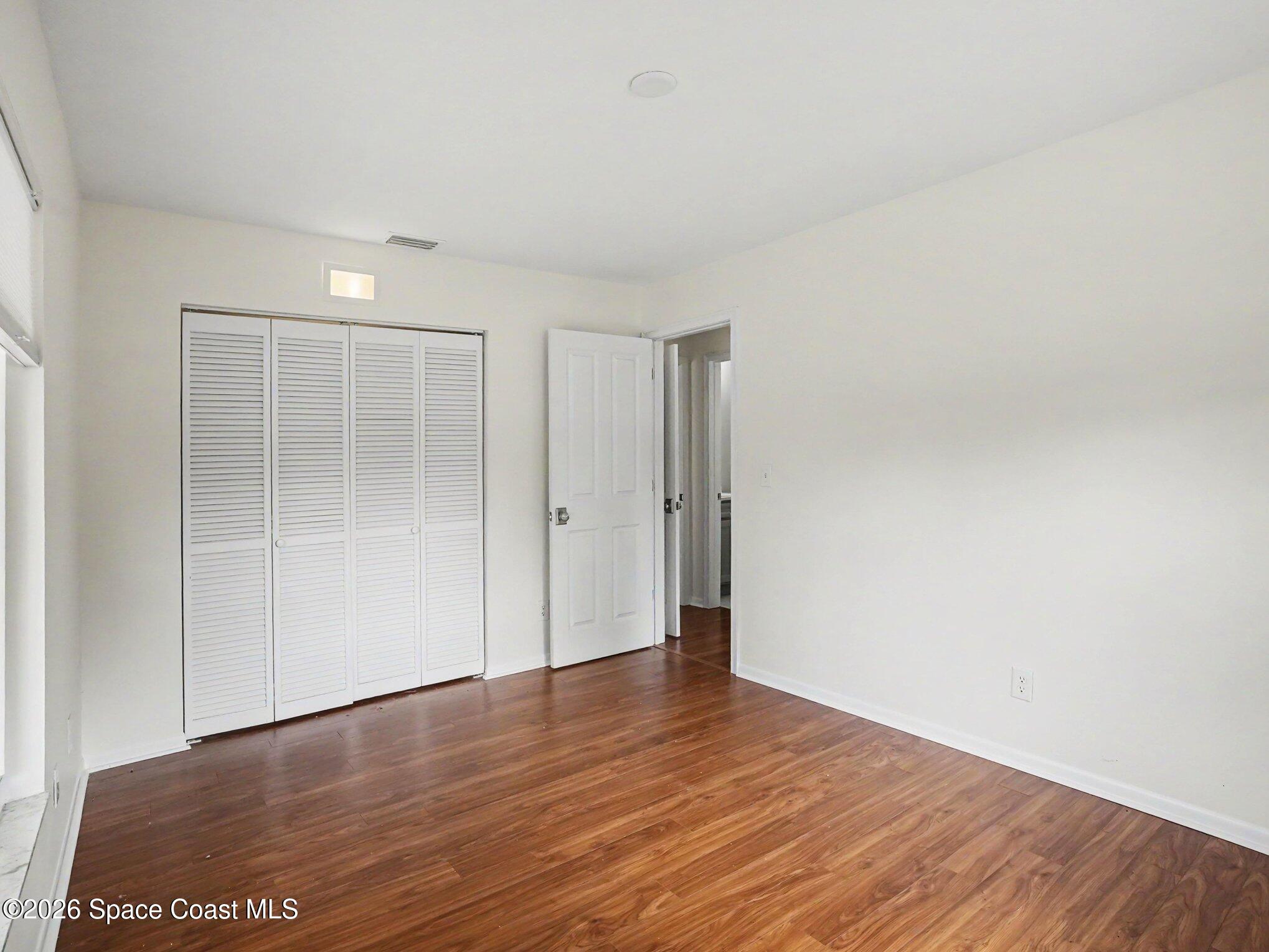 1870 Tallpalm Road Melbourne, FL 32935 - Photo 21 of 30 a view of an empty room with wooden floor
