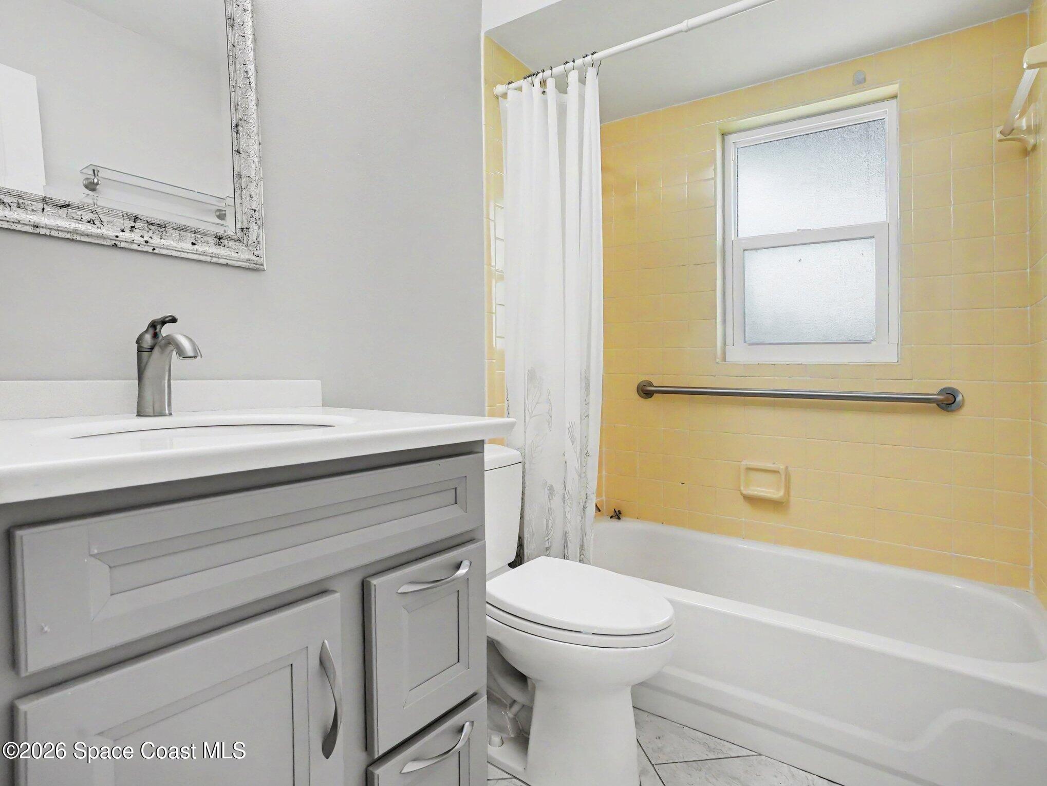 1870 Tallpalm Road Melbourne, FL 32935 - Photo 22 of 30 a bathroom with a sink a toilet and shower