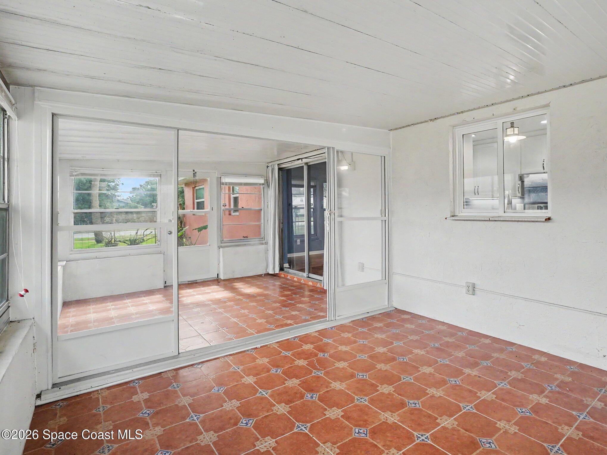 1870 Tallpalm Road Melbourne, FL 32935 - Photo 24 of 30 a big room with wooden floor and windows