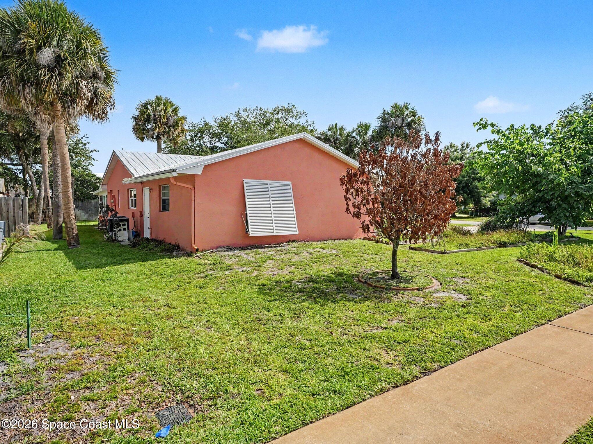 1870 Tallpalm Road Melbourne, FL 32935 - Photo 27 of 30 a front view of a house with garden