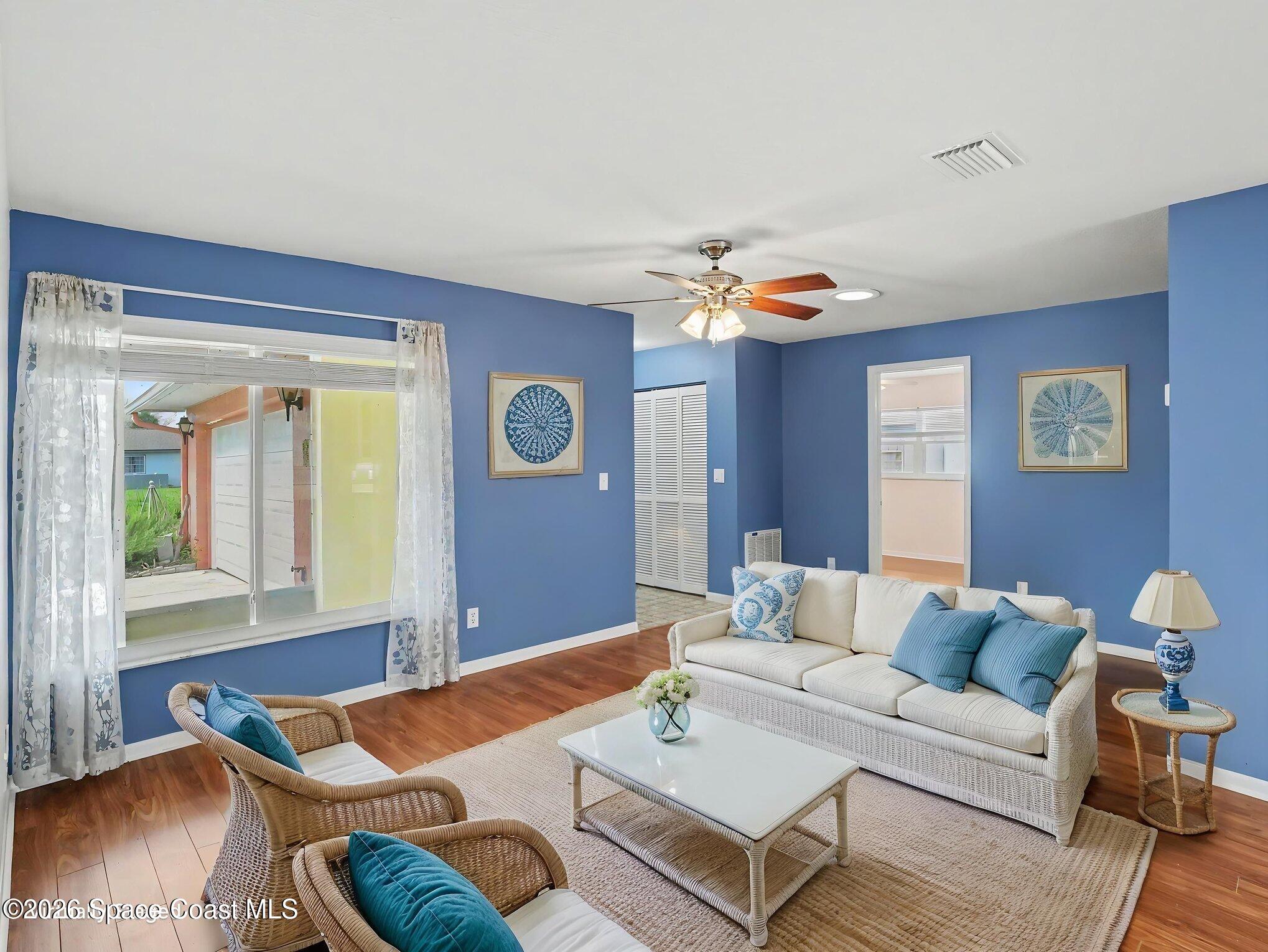 1870 Tallpalm Road Melbourne, FL 32935 - Photo 6 of 30 a living room with furniture and wooden floor