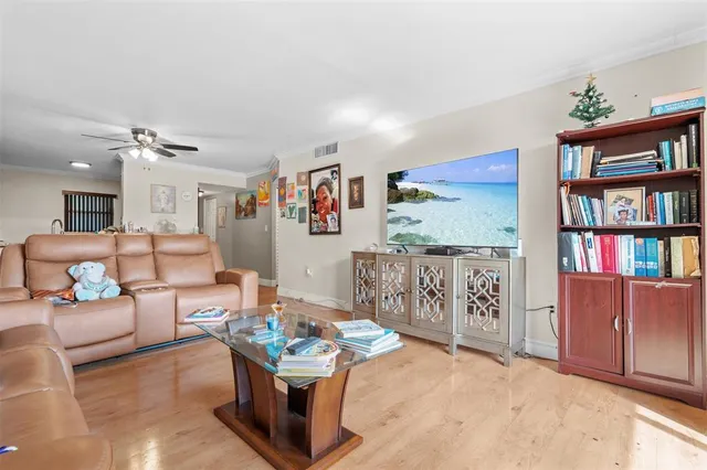 a living room with furniture a book shelf and a bookshelf