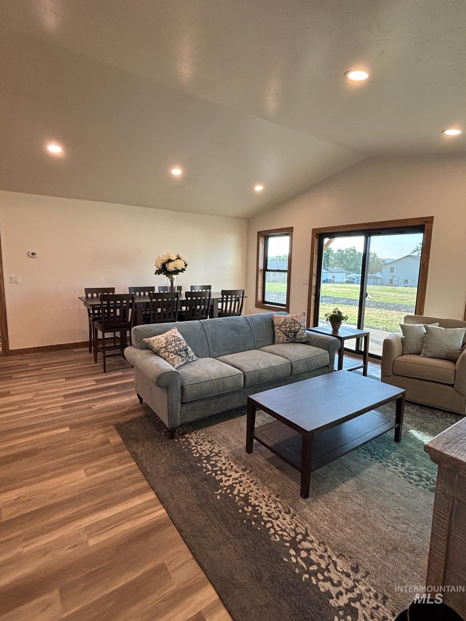 2219 Powers Drive Lewiston, ID 83501 - Photo 15 of 31 Living room featuring wood finished floors, recessed lighting, and lofted ceiling