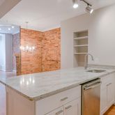 a kitchen with granite countertop a sink and a window
