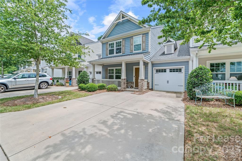 3144 Graceland Circle Pineville, NC 28134 - Photo 1 of 24 a front view of a house with a yard and potted plants