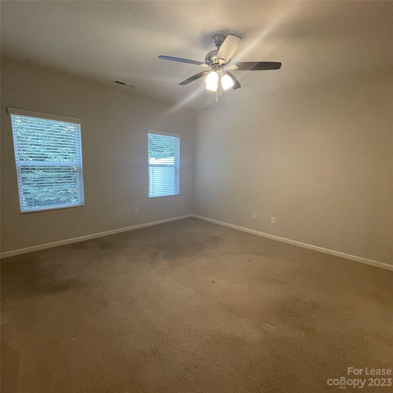 3144 Graceland Circle Pineville, NC 28134 - Photo 11 of 24 an empty room with windows and fan