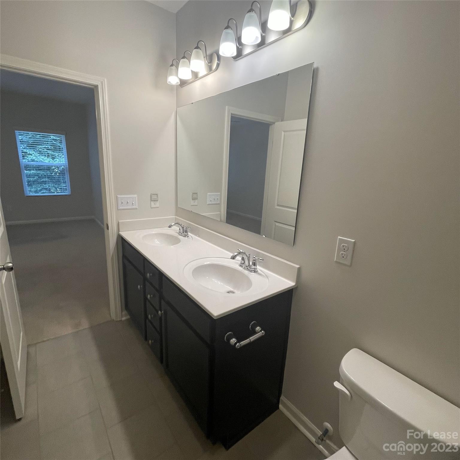 3144 Graceland Circle Pineville, NC 28134 - Photo 14 of 24 a bathroom with a toilet sink and mirror