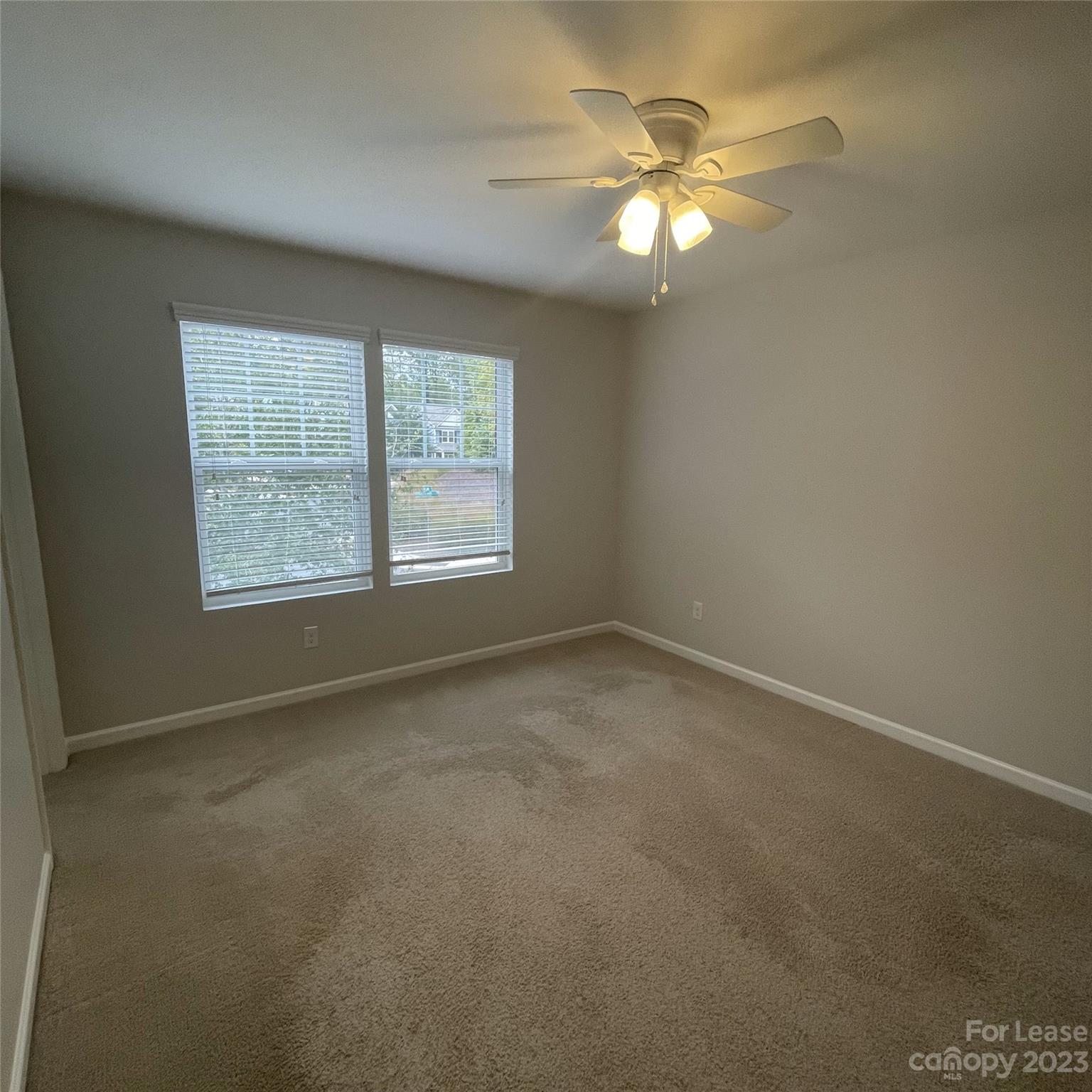 3144 Graceland Circle Pineville, NC 28134 - Photo 23 of 24 an empty room with a window and a ceiling fan