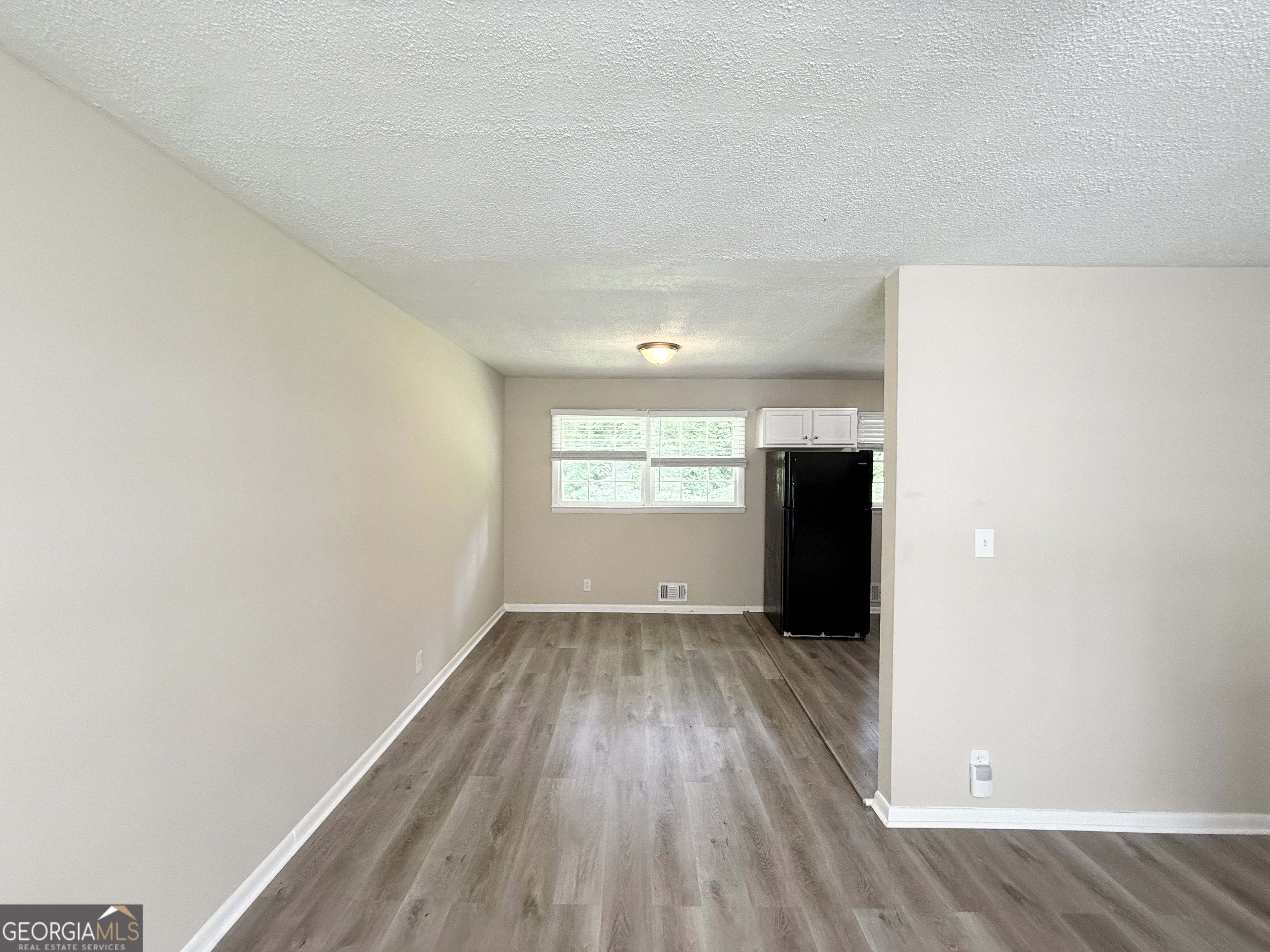 2782 Ocean Valley Road Atlanta, GA 30349 - Photo 5 of 27 a view of an empty room with wooden floor and a window