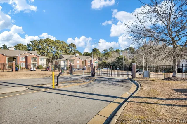 an empty room with wooden floor ceiling fan and window