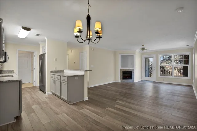 a kitchen with granite countertop a sink stove and cabinets