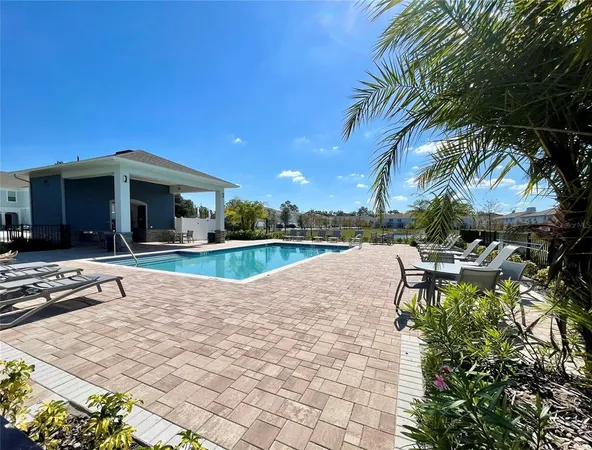 a view of a house with swimming pool and sitting area
