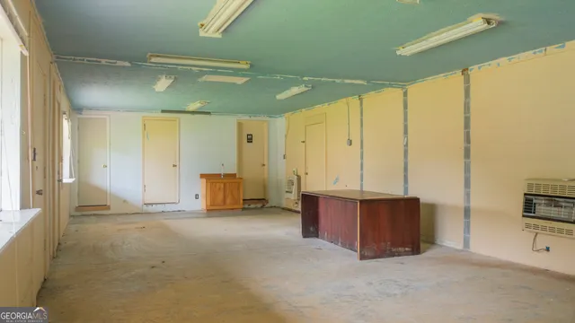 a view of a tennis ground with large trees