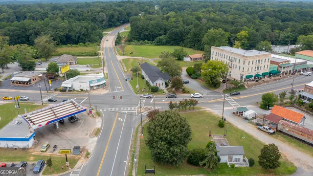 a front view of a house with a garden and yard