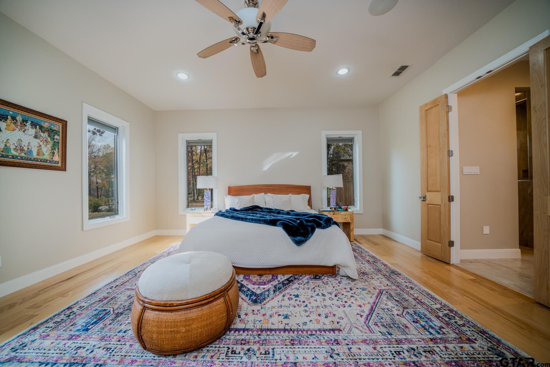 3 Lakeside Drive Longview, TX 75604 - Photo 16 of 41 a bedroom with a bed and wooden floor