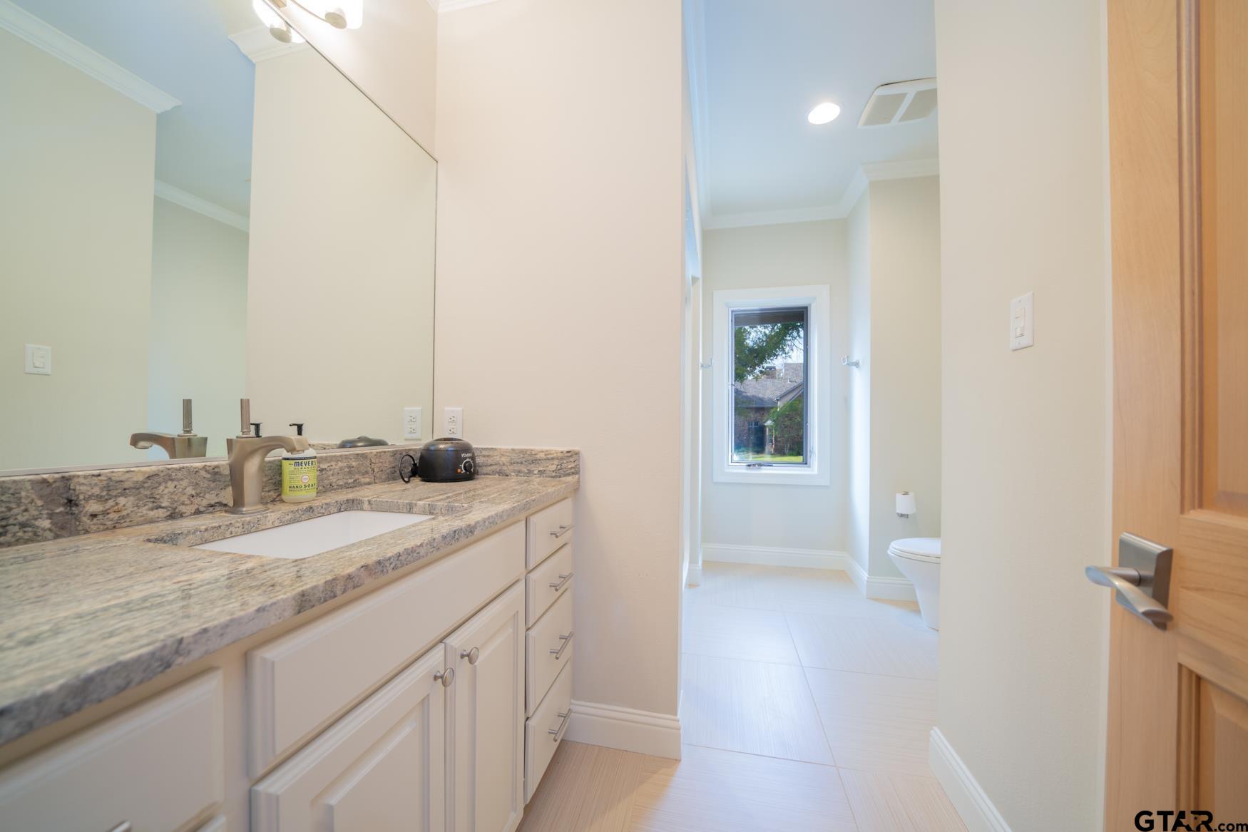 3 Lakeside Drive Longview, TX 75604 - Photo 26 of 41 a bathroom with a granite countertop sink and a mirror