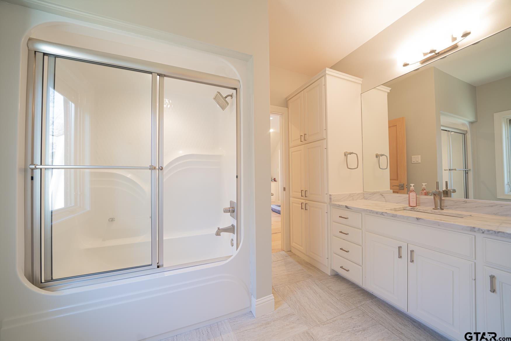 3 Lakeside Drive Longview, TX 75604 - Photo 29 of 41 a bathroom with a double vanity sink and a mirror