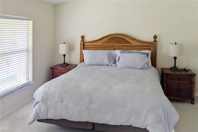 a bedroom with bed and window
