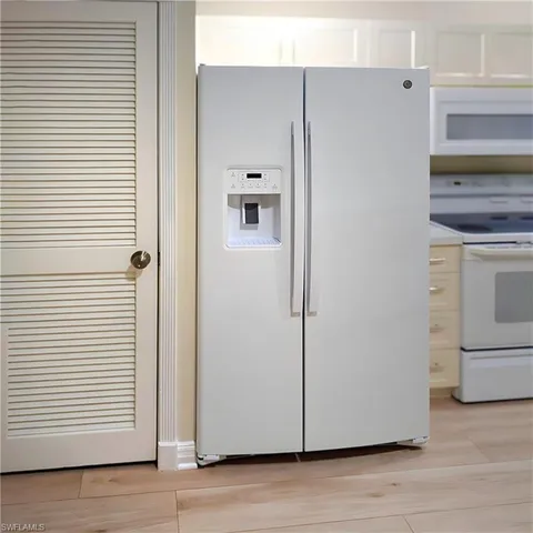a kitchen with stainless steel appliances a refrigerator sink and microwave