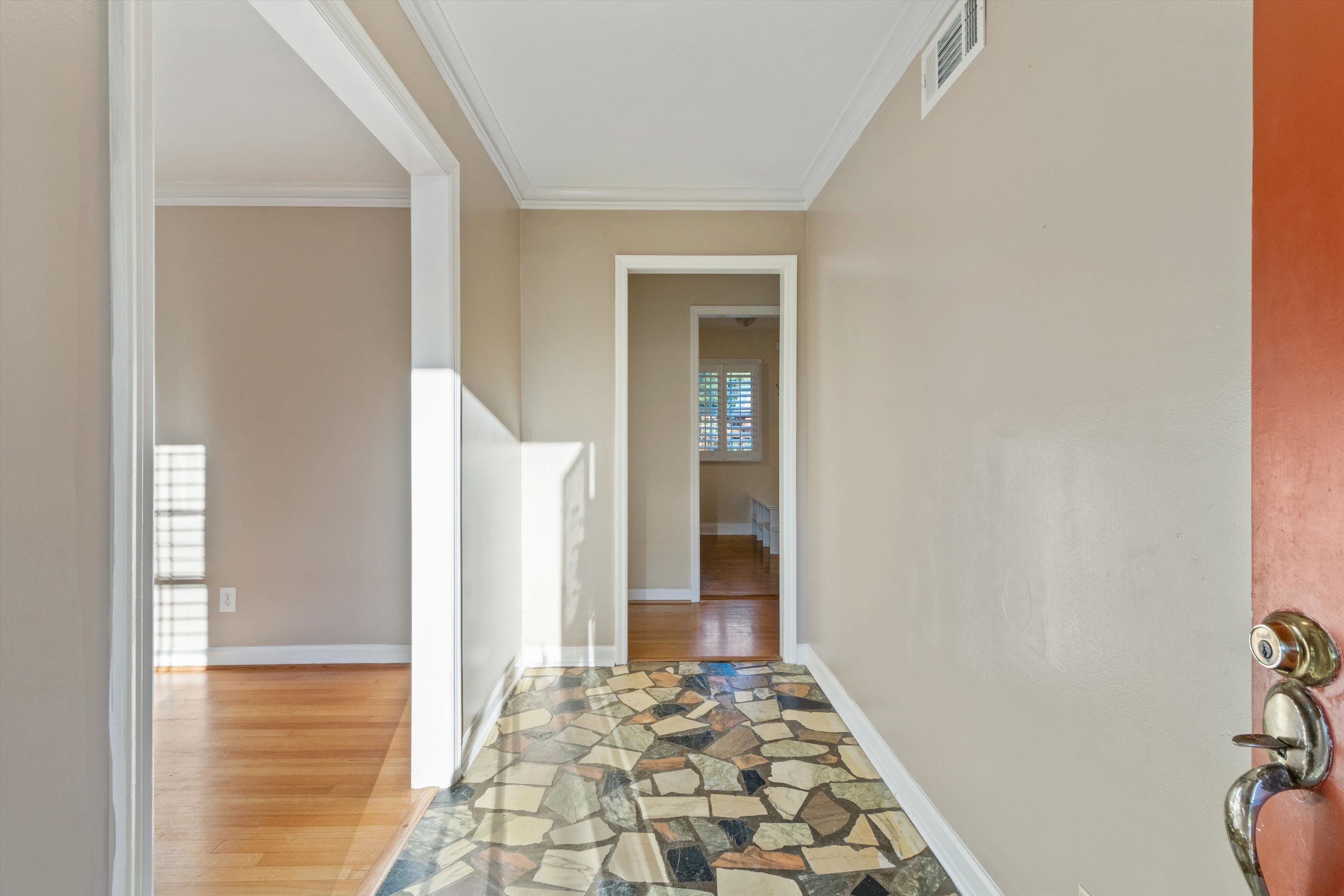 4472 Fair Meadow Road Memphis, TN 38117 - Photo 3 of 33 a view of a hallway with wooden floor and a livingroom