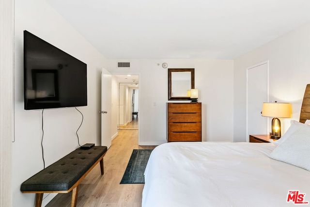 a bathroom with a bathtub shower sink vanity and toilet