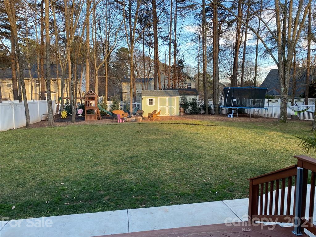 19106 Ruffner Drive Cornelius, NC 28031 - Photo 2 of 3 a view of a swimming pool with a bench and trees