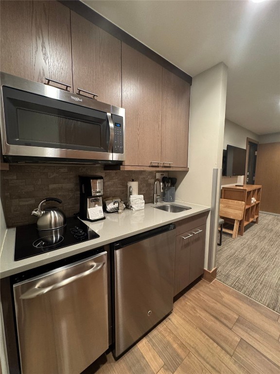 1627 Ski Hill Road, Unit 2236EGHI Breckenridge, CO 80424 - Photo 18 of 23 a kitchen with granite countertop stainless steel appliances and wooden cabinets