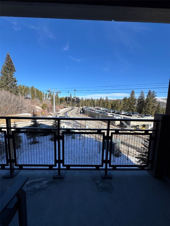 1627 Ski Hill Road, Unit 2236EGHI Breckenridge, CO 80424 - Photo 23 of 23 a view of a balcony with wooden floor and a table