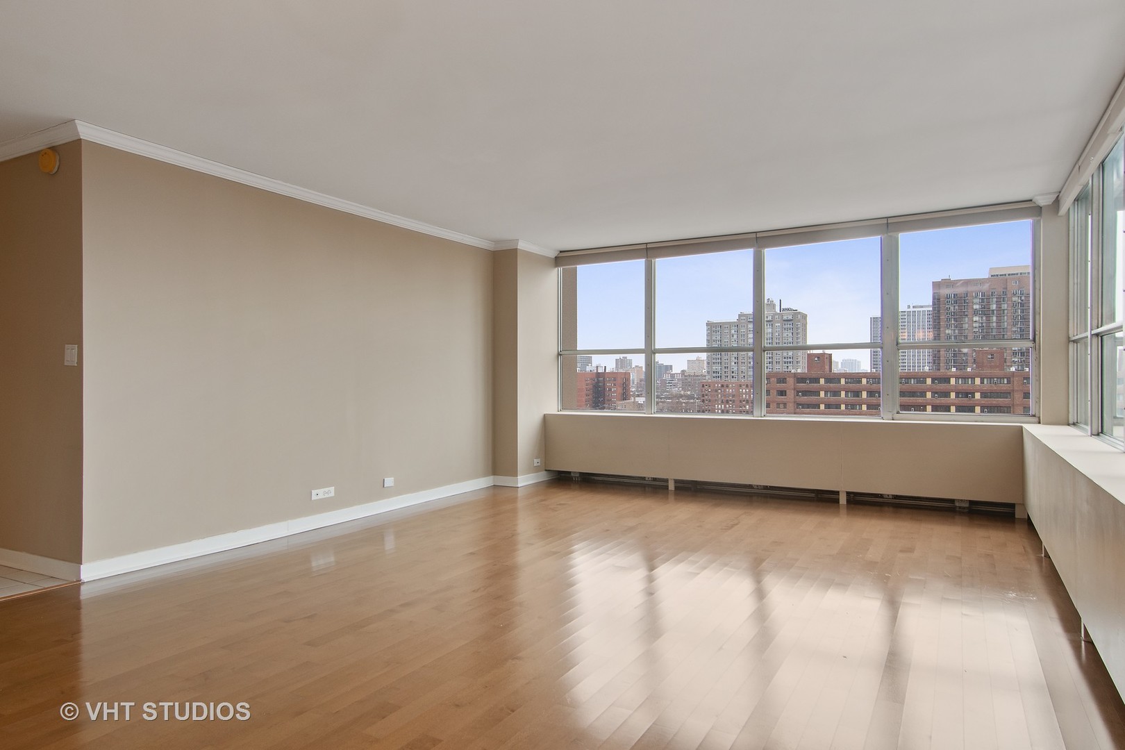 655 West Irving Park Road, Unit 910 Chicago, IL 60613 - Photo 5 of 14 a view of a big room with wooden floor and windows