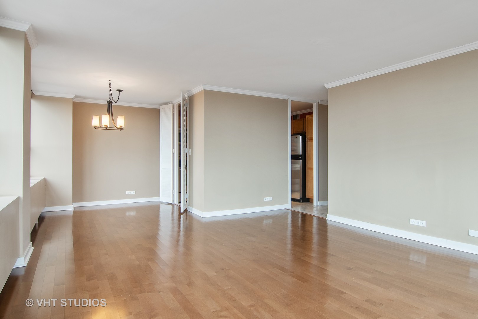 655 West Irving Park Road, Unit 910 Chicago, IL 60613 - Photo 6 of 14 a view of an empty room with wooden floor and a window