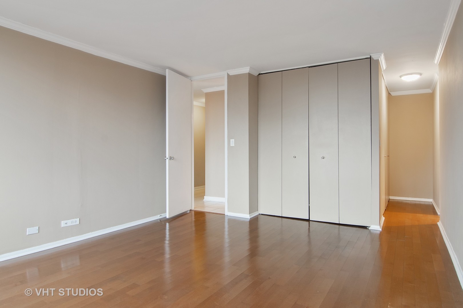 655 West Irving Park Road, Unit 910 Chicago, IL 60613 - Photo 9 of 14 a view of an empty room with wooden floor