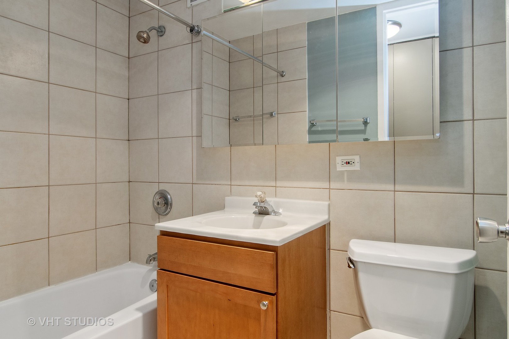 655 West Irving Park Road, Unit 910 Chicago, IL 60613 - Photo 10 of 14 a bathroom with a sink toilet and shower