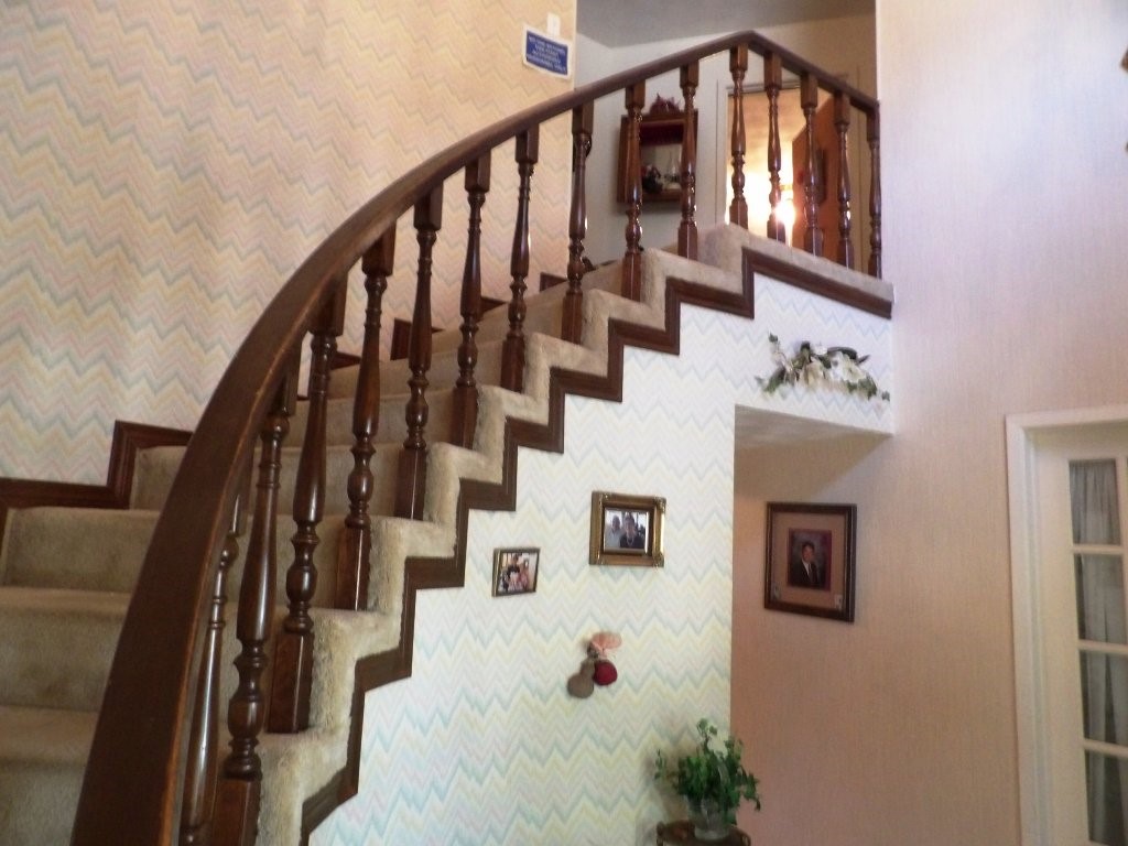 a view of staircase with wooden floor and white walls