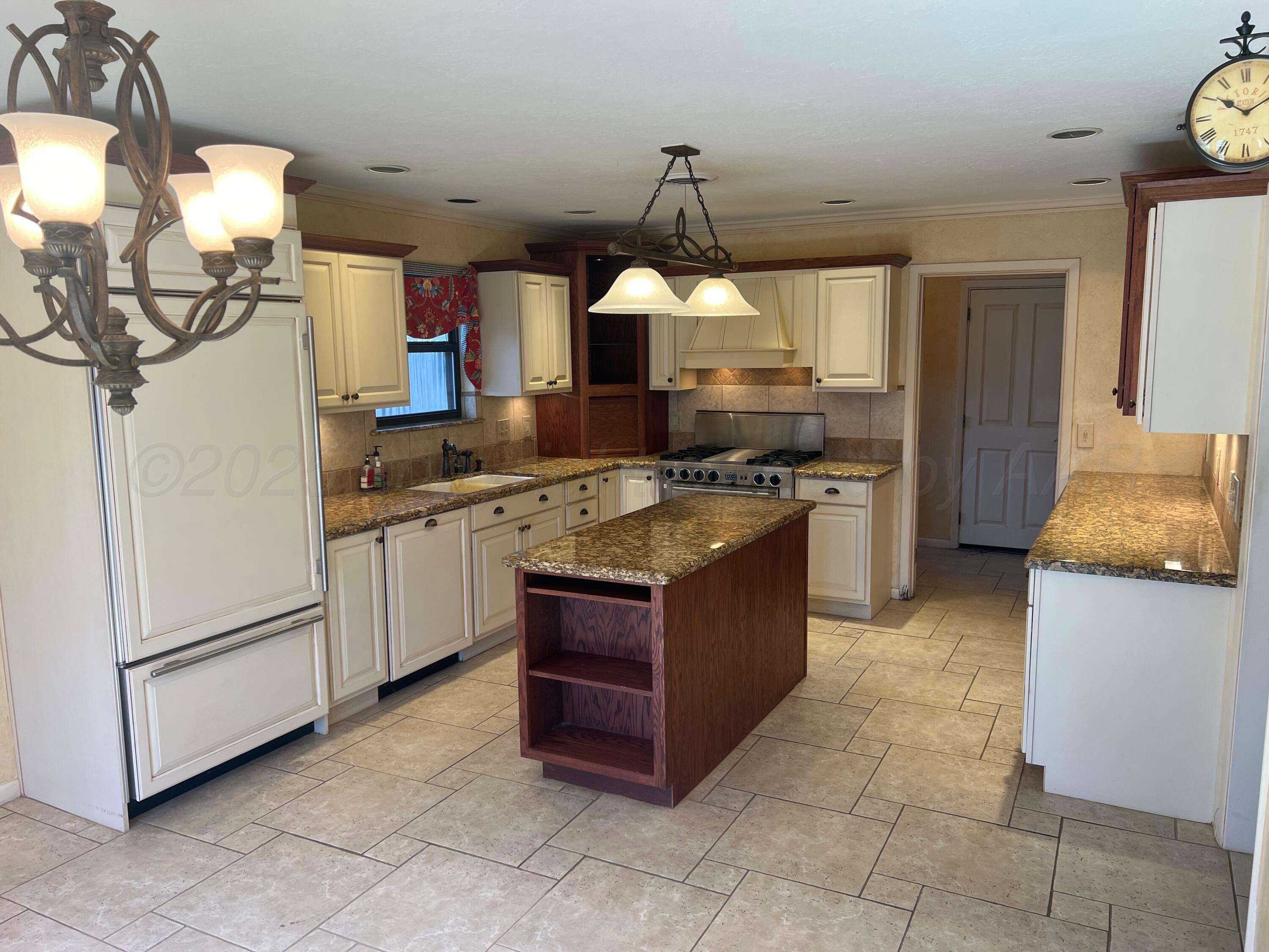 7115 Gainsborough Road Amarillo, TX 79106 - Photo 11 of 81 a kitchen with stainless steel appliances granite countertop a stove and a sink