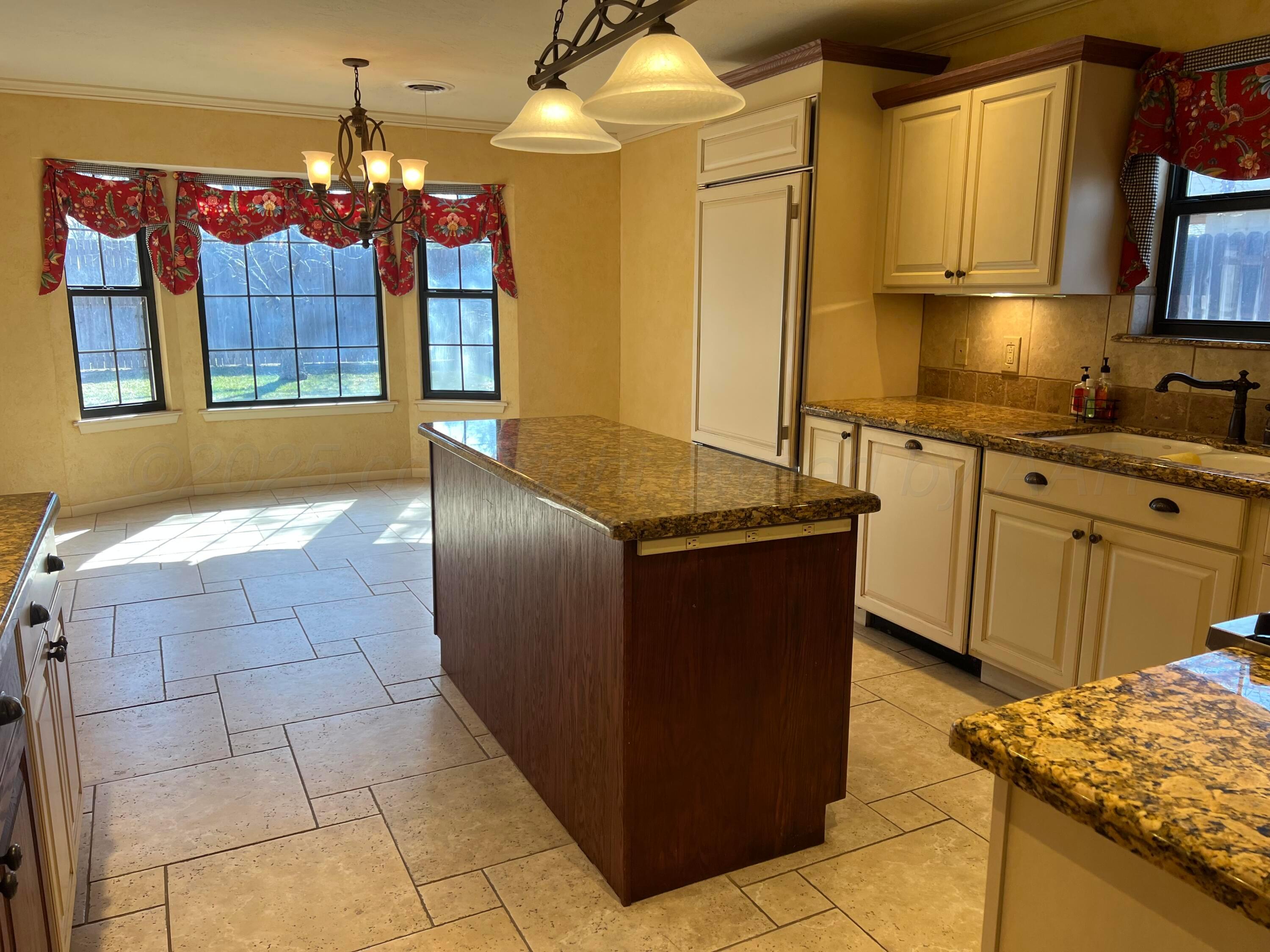7115 Gainsborough Road Amarillo, TX 79106 - Photo 15 of 81 a kitchen with granite countertop a sink and a stove