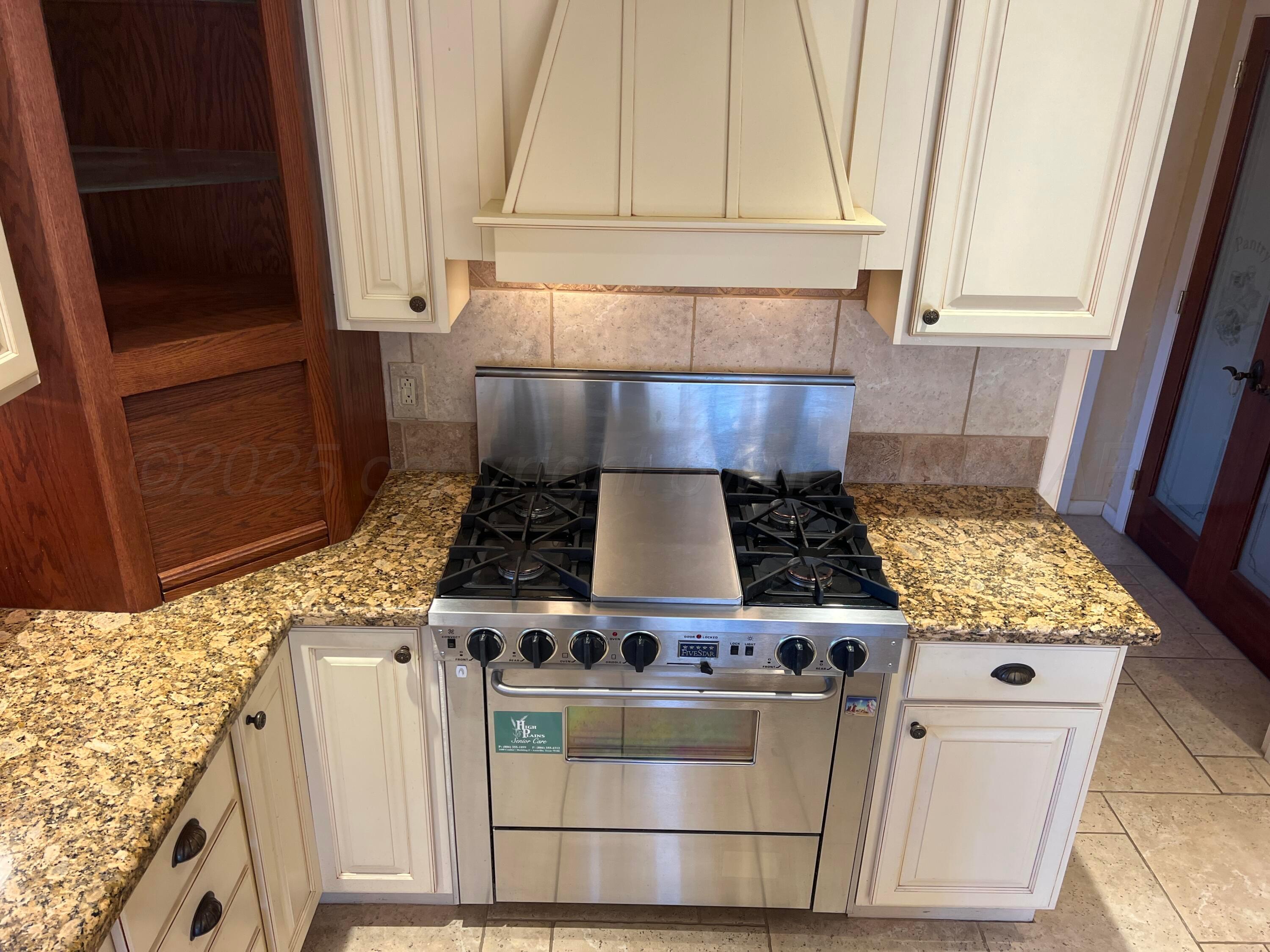 7115 Gainsborough Road Amarillo, TX 79106 - Photo 16 of 81 a stove top oven sitting inside of a kitchen