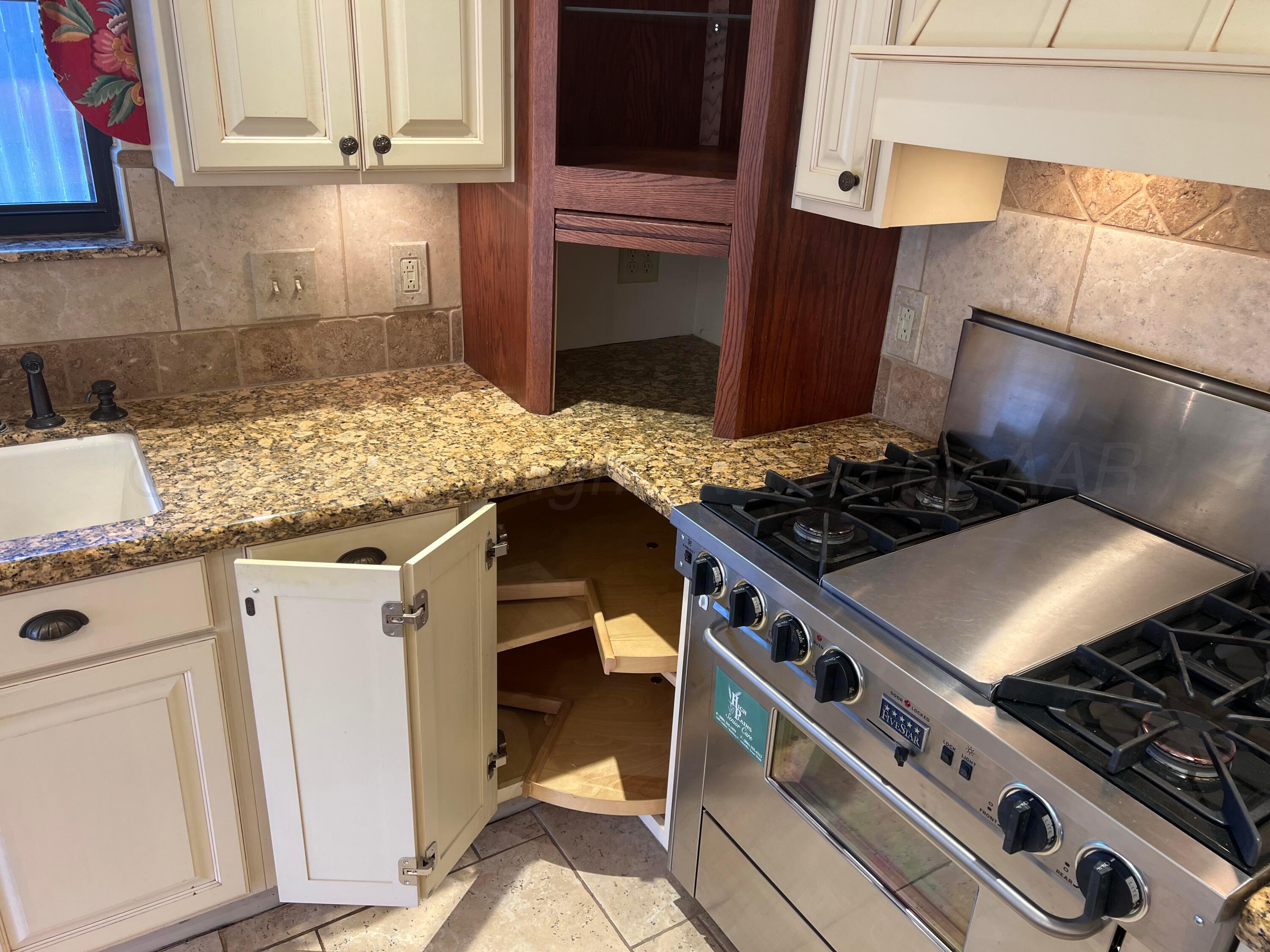 7115 Gainsborough Road Amarillo, TX 79106 - Photo 17 of 81 a kitchen with stove and cabinets