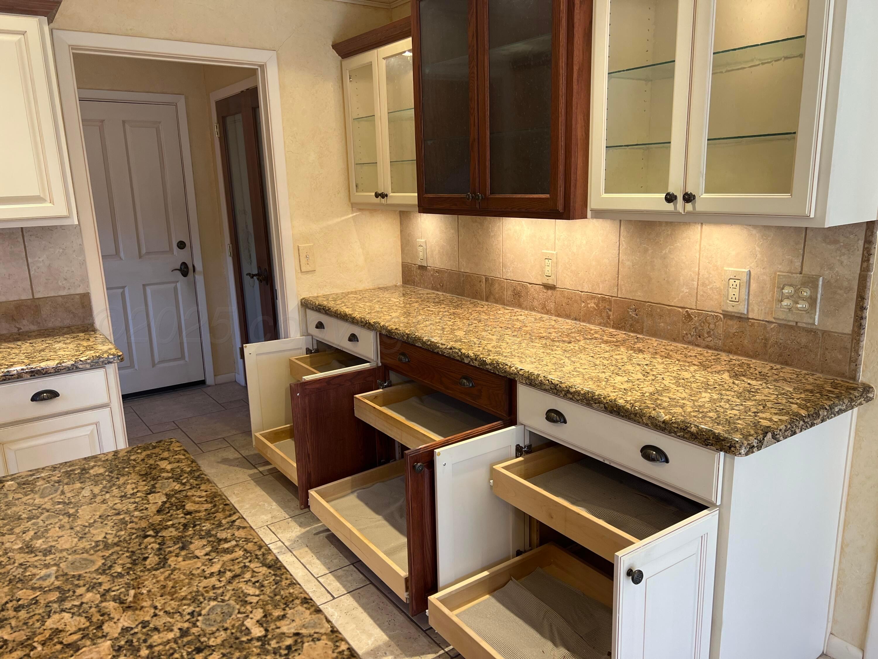 7115 Gainsborough Road Amarillo, TX 79106 - Photo 21 of 81 a kitchen with granite countertop a stove and a sink